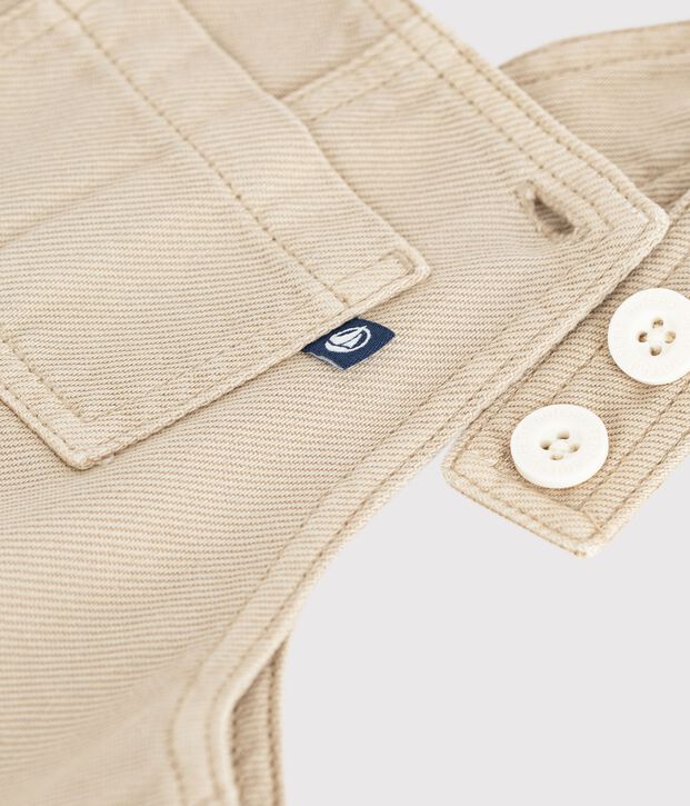 Langbeinige Baby-Latzhose aus einfarbigem Serge. beige