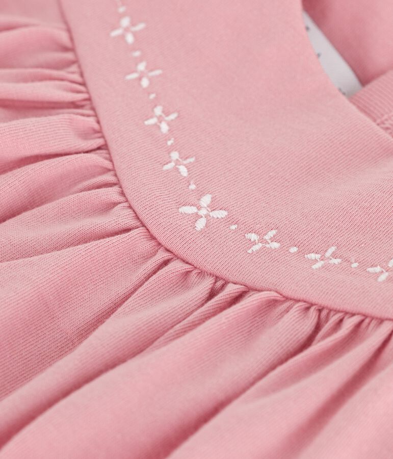 &Auml;rmelloses Baby-Kleid aus einfarbiger Baumwolle mit gestickten Verzierungen am Kragen rosa
